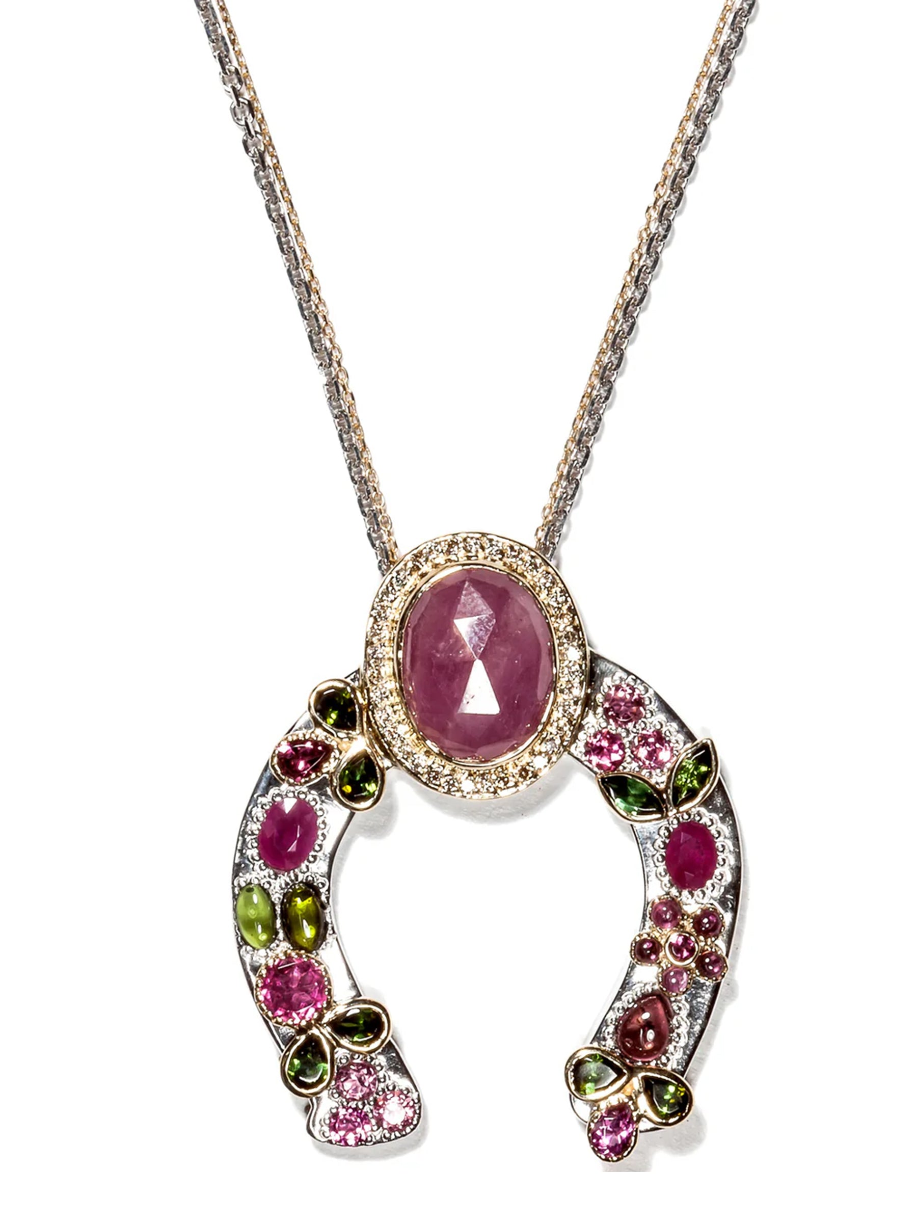 Horseshoe necklace with pink sapphire, tourmaline accents, diamond crown, and hand-placed gold leaves on palladium- and rhodium-treated sterling silver, shown on white background.