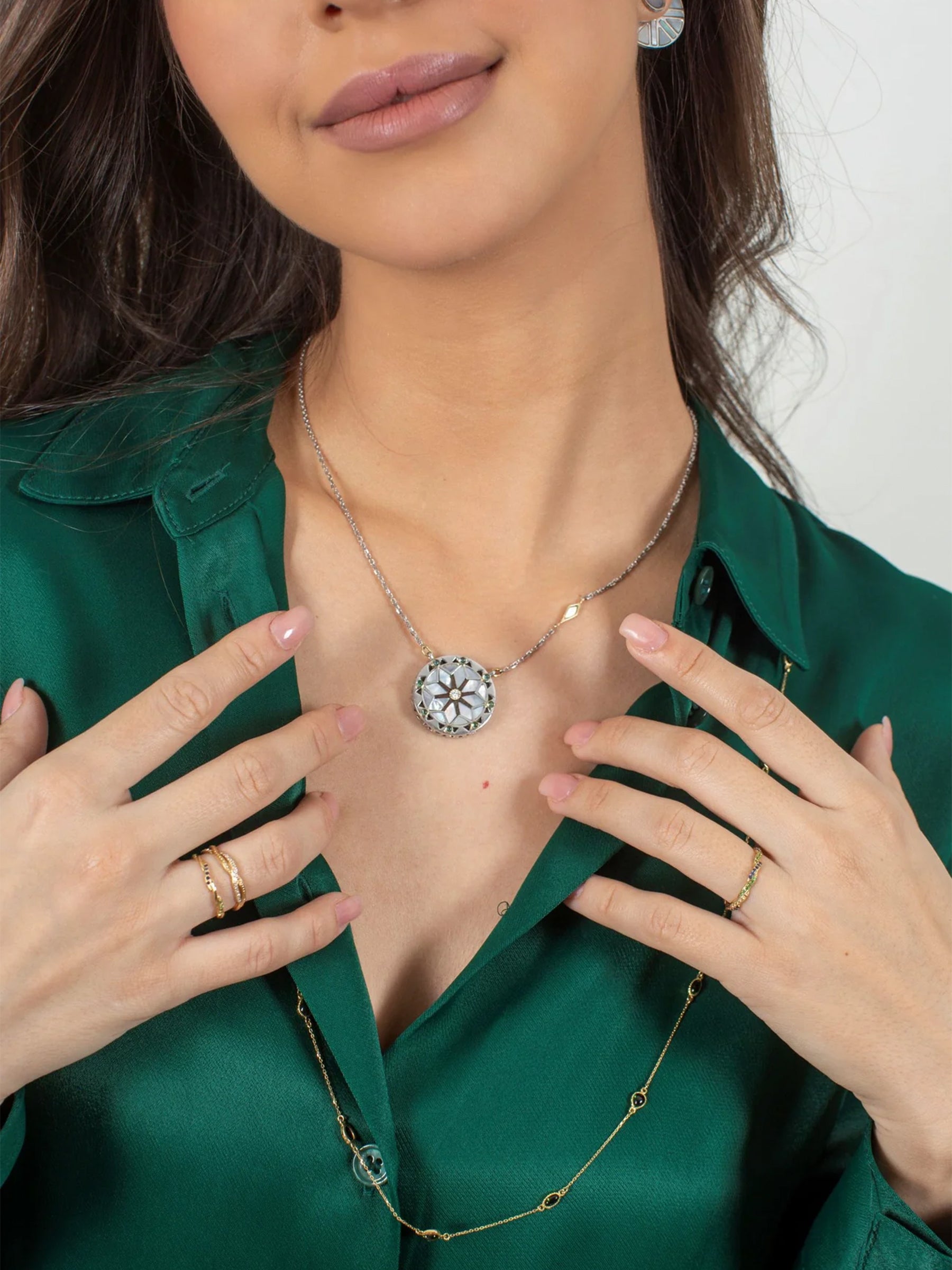Model wearing Mavia pearl necklace in gold and sterling silver with diamonds, tourmaline, and wood inlay.