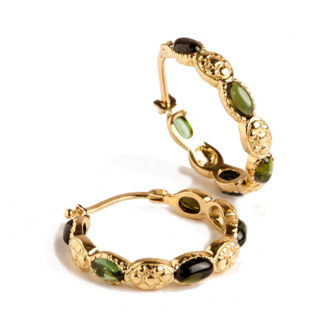 A pair of gold hoop earrings with green oval cabochons, displayed against a white background.