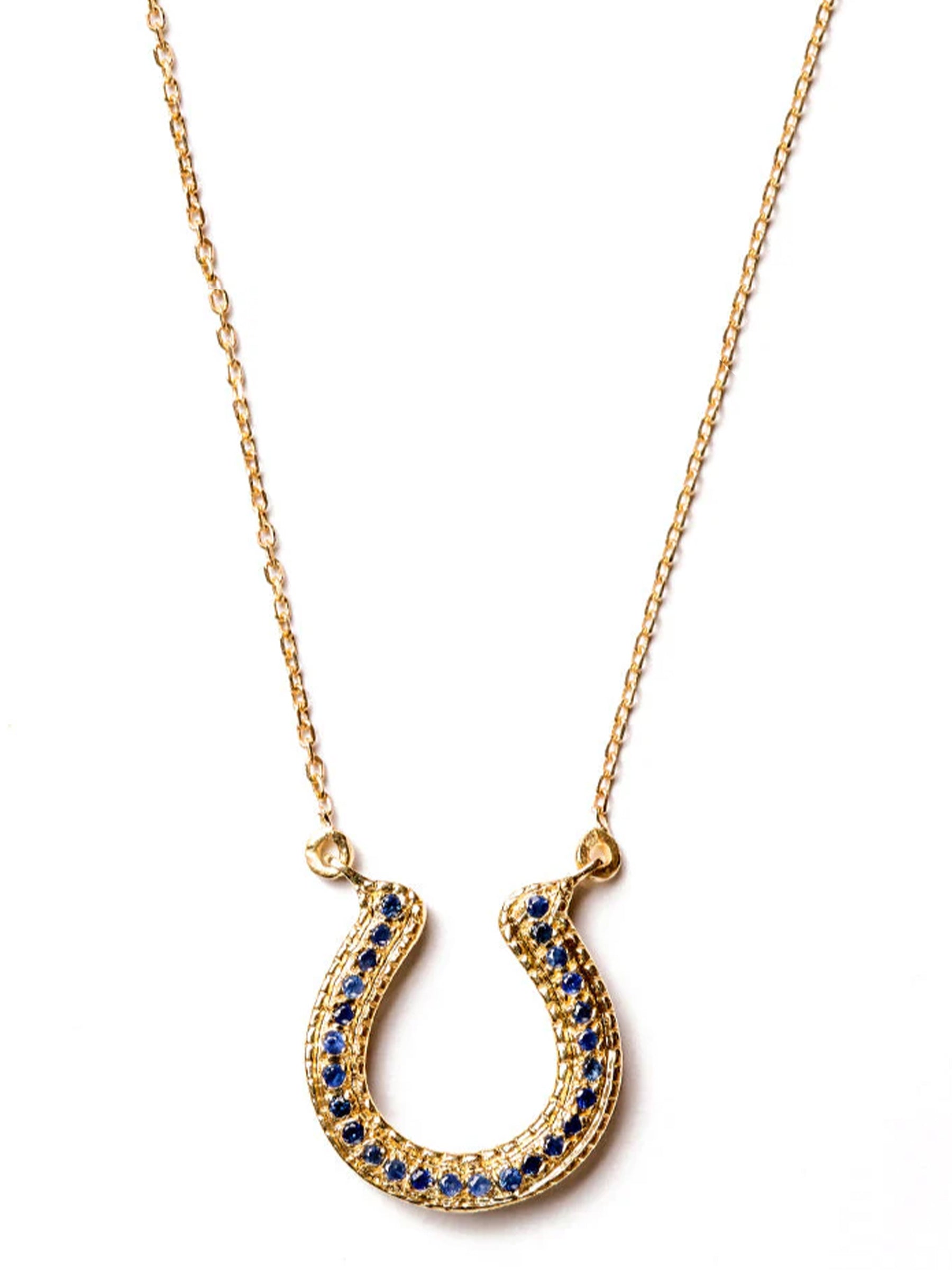 Handcrafted 18k gold horseshoe necklace with blue sapphire on a fine chain.