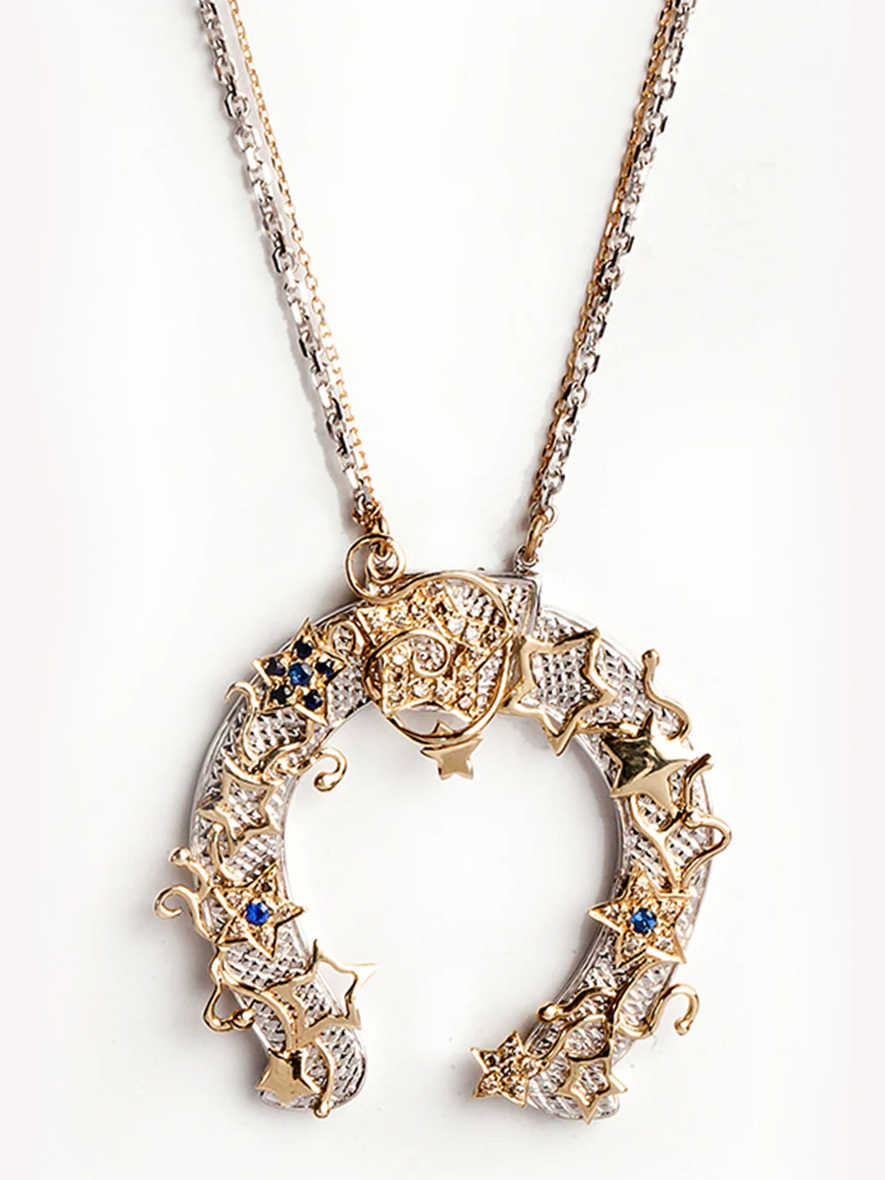 Zoom in Horseshoe Pendant Necklace in 14k Gold and Silver with Blue Sapphire, Diamonds, and Engraved Design on a white background. 