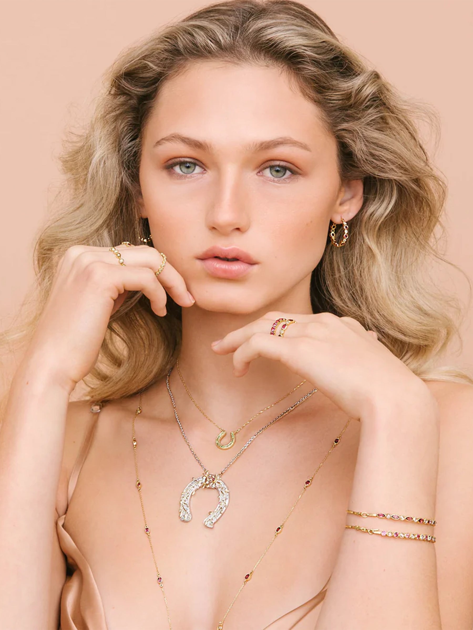 Model wearing layered necklaces with the Horseshoe Spiralling Branches Necklace, handcrafted in 14k gold and sterling silver with natural tourmalines and diamonds.