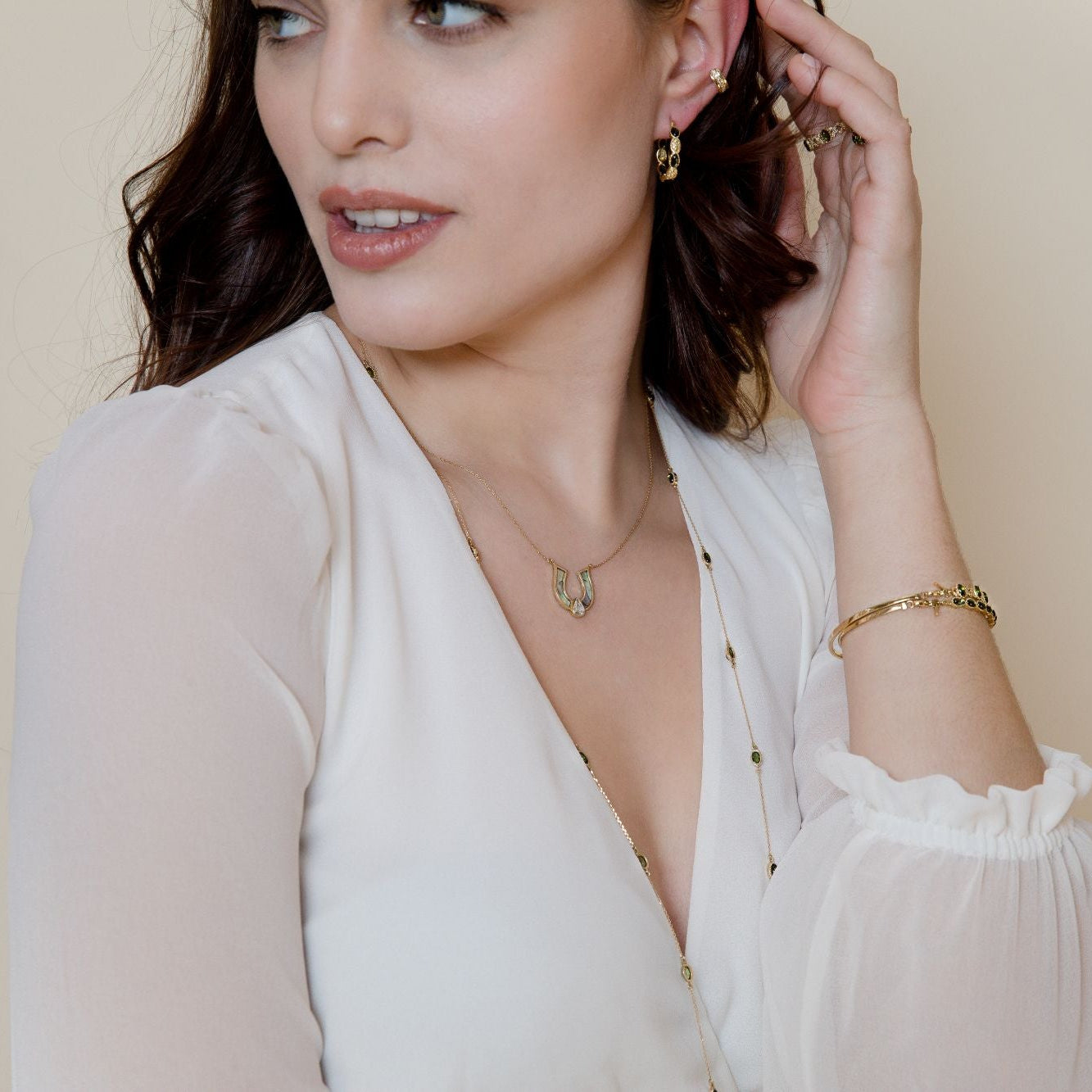 model wearing horseshoe green mother  of pearl necklace 